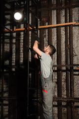 Wall Mural - The lighting engineer adjusts the lights on stage behind the scenes