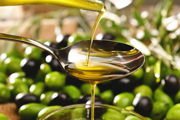 Genuine Italian organic oil cold pressed in slow motion falls on organic bread. concept of nature and healthy food, healthy and natural. fresh olives and Tuscan Italian oil