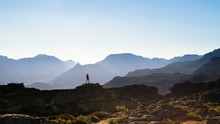 The Silhouette Of A Trail Runner Running Along A Rocky Mountain Ridge At Sunset In The Mountains Of South Africa