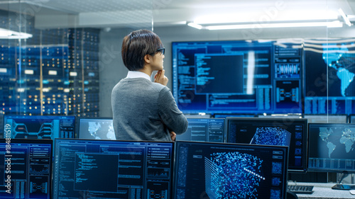 In The System Control Room Technical Operator Stands And