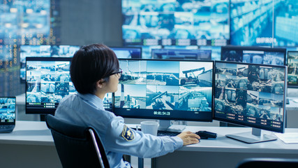 Aufkleber - In the Security Control Room Officer Monitors Multiple Screens for Suspicious Activities, He Drinks from a Mug. He's Surrounded by Monitors and Guards Port of National Importance.
