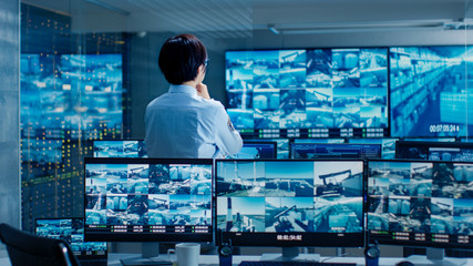 Poster - In the Security Control Room Officer Monitors Multiple Screens for Suspicious Activities. He Guards Internationally Important Logistics Facility.