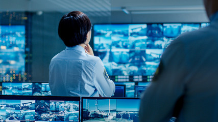 Leinwandbilder - In the Security Control Room Officer Monitors Multiple Screens for Suspicious Activities. He Guards Internationally Important Logistics Facility.