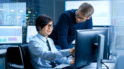 Aufkleber - In the Data Mining Center Chief Statistician Consults His Young Assistant sits at His Workstation Surrounded with Monitors Displaying Data and Graphs.