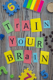 Fototapeta Młodzieżowe - Train your brain inscription on a wooden background