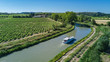 © Iuliia Sokolovska - Aerial top view of boat in Canal du Midi from above, family travel by barge and vacation in Southern France