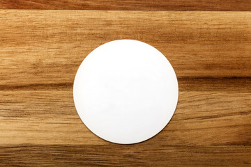 Wall Mural - Mockup of round white business card on rustic background