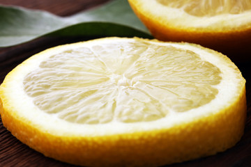 Wall Mural - Pile of lemons with leaves on brown wooden table