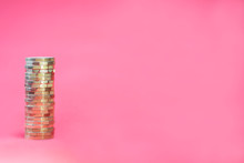 Stacked Pound Coins On Pink Background With Negative Copy Space