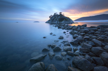 Fog and mist roll into Whytecliff Park at sunset producing some vivid colors in West Vancouver BC Canada.