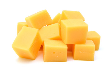 Cubes of cheddar cheese isolated on white