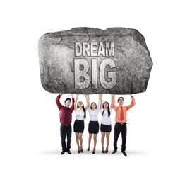 Wall Mural - Business team lifting text of dream big
