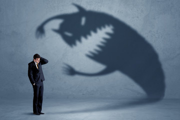 Wall Mural - Business man afraid of his own shadow monster concept
