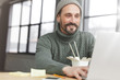 © WHstudio Leushin N - Portrait of cheerful pleased male manager has dinner break after work, eats tasty pasta with chopsticks, sends feedback on laptop computer to friend, happy to get good job offer. People, success