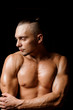 © fesenko - Strong, muscular and tanned bodybuilder looking away