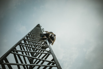 Telecom Worker Climbing Antenna Tower