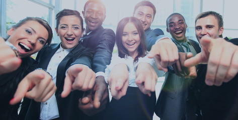 Poster - Happy multi-ethnic business team with thumbs up in the office