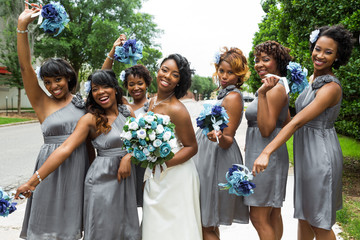 Bride and bridesmaids having fun.