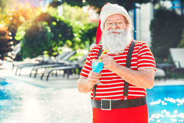 Santa Claus near the pool holiday vacation concept