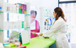 © Karanov images - Pharmacist discusses prescription medication with senior customer at pharmacy