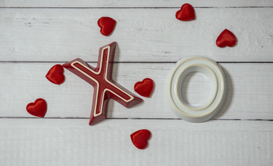 X's and O's for Valentine's Day on wood background