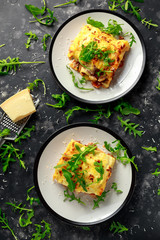 Wall Mural - Homemade lasagna with minced beef bolognese and bechamel sauce topped wild arugula, parmesan cheese