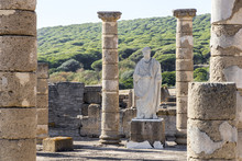 Statue Of Roman Emperor Trajan In The Ruins Of Baelo Claudia, An Ancient Roman Town Outside Of Tarifa, Near The Village Of Bolonia, In Andalusia, Southern Spain