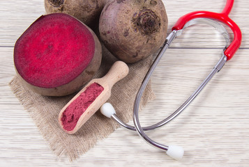 Wall Mural - Healthy beetroot juice and fresh vegetables on wooden background.