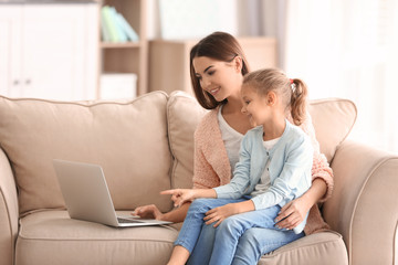 Wall Mural - Busy young woman with daughter in home office