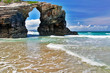 The rock in the form of an arch on the ocean beach