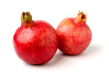 Wall Mural - Two pomegranate on a white background, closeup.