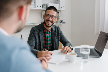 company recruiter filling out hr questionnaire at a job interview