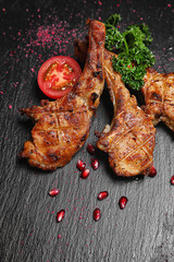 Wall Mural - Tasty grilled ribs on dark background