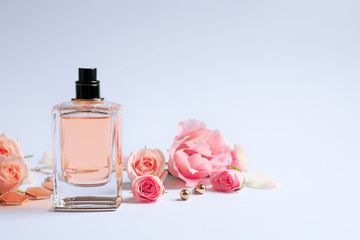 Wall Mural - Bottle of perfume with flowers on white background