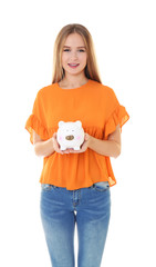 Canvas Print - Young woman holding piggy bank on white background