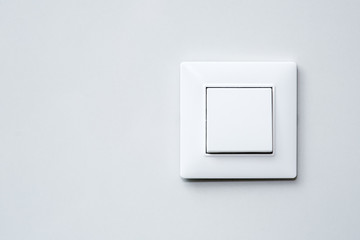 Wall Mural - a light switch on gray wall.