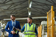 © Seventyfour - Portrait of young workman giving tour of modern factory to handsome mature businessman discussing possible investment, copy space