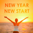 © Maridav - NEW YEAR NEW START motivational message, inspirational quotes for the New Year resolution in fitness weight loss. Happy woman with arms up in success winning at the sky for new life challenge.