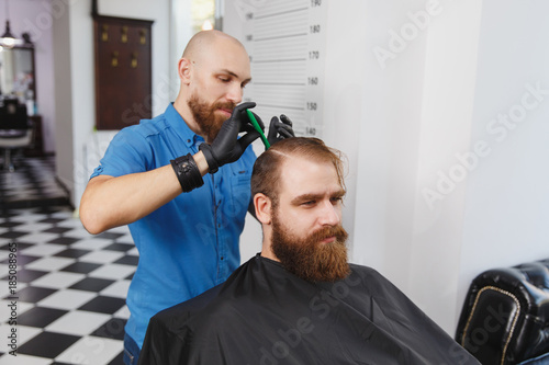 Male Professional Hairdresser Serving Client By Clipper Ginger