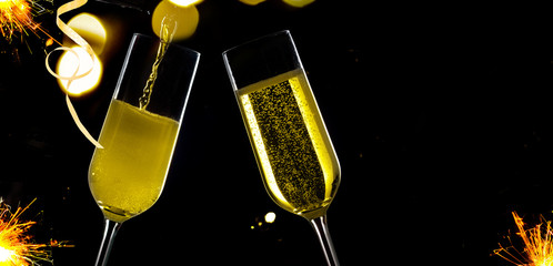 Wall Mural - Two festive champagne glasses on black background with copy sace