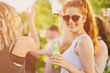 © chika_milan - Ginger girl dancing, drinking an having a good time at outdoor party