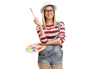 Poster - Young woman with a paintbrush and a color palette