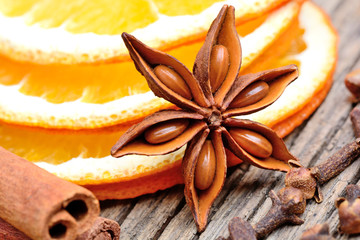 Canvas Print - Dry slices of orange with anise star cinnamon and cloves on table