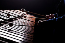 The Hands Of A Musician Playing The Marimba In Dark Tones