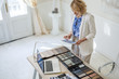 © LUMINA IMAGES - Pretty Caucasian woman interior designer working on tablet at her office.