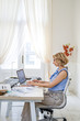 © LUMINA IMAGES - Elegant woman interior designer working on laptop at her studio.