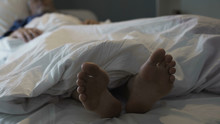 Retired Man Sleeping In Bed, Nasty Smell And Discomfort Due To Foot Fungus
