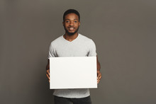 Picture Of Young African-american Man Holding White Blank Board
