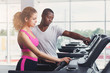 © Prostock-studio - Fitness instructor helps young woman on treadmill