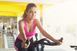 © Prostock-studio - Woman in gym on exercise bikes
